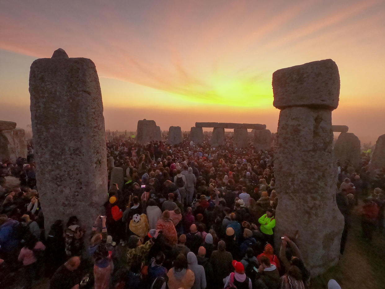 People gather for sunrise at Stonehenge during the summer solstice