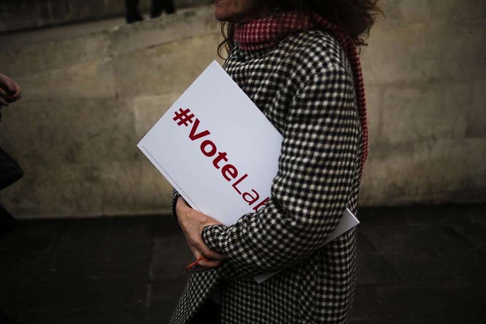 <p>A woman walks over the London Bridge carrying a placard, in London, Tuesday, June 6, 2017. Britain will hold a general election on June 8. (Photo: Markus Schreiber/AP) </p>