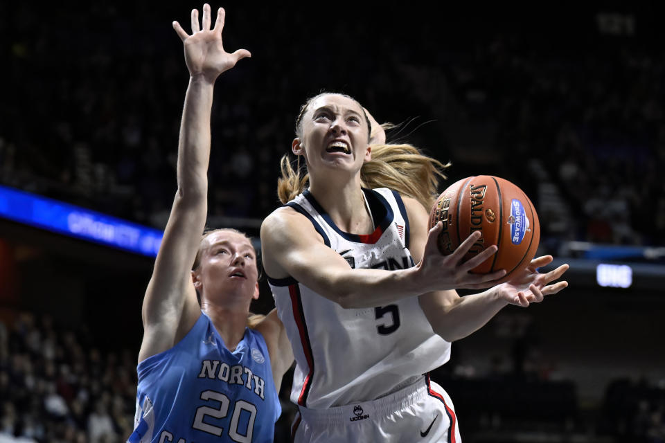 UConn guard Paige Bueckers drives to the basket as North Carolina guard Lexi Donarski (20) defends in the first half of an NCAA college basketball game, Sunday, Dec. 10, 2023, in Uncasville, Conn. (AP Photo/Jessica Hill)