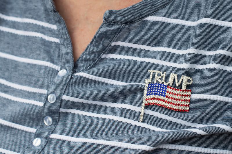 A U.S. President Donald Trump's supporter wearing a patriotic pin gathers outside an event for Joe Biden, Democratic 2020 U.S. presidential candidate and former vice president before a campaign stop in Lancaster