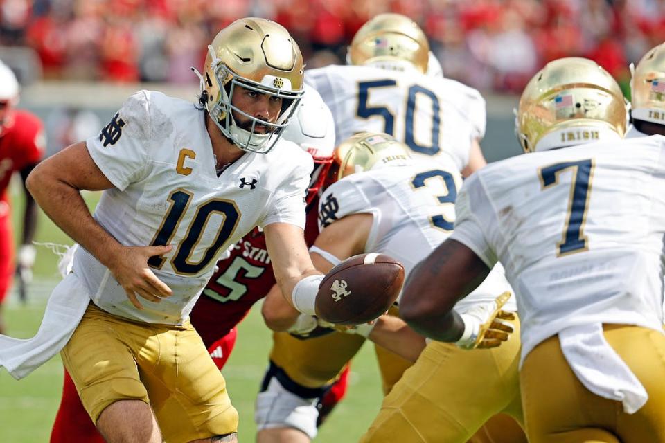 Notre Dame's Sam Hartman (10) hands the ball off to Audric Estime (7) during the second half of an NCAA college football game against North Carolina State in Raleigh, N.C., Saturday, Sept. 9, 2023. (AP Photo/Karl B DeBlaker)