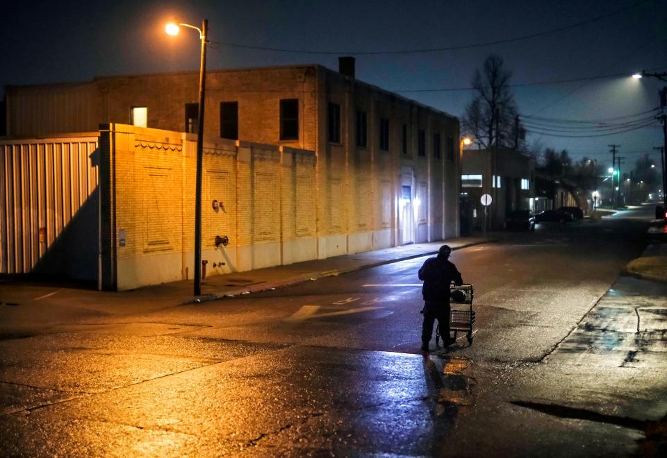 A man pushes his cart south early Thursday along Indiana after speaking with a team of volunteers during the Oklahoma City Point-In-Time survey.