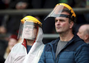 Spectators wear masks in the stands during the Six Nations international rugby union match between England and Wales at Twickenham Stadium, London, Saturday March 7, 2020. (Adam Davy/PA via AP)