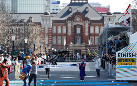 Athletics - Tokyo Marathon 2017 - Tokyo, Japan - 26/02/17 - Winner Wilson Kipsang of Kenya crosses the finish line near the Tokyo Station building. REUTERS/Toru Hanai