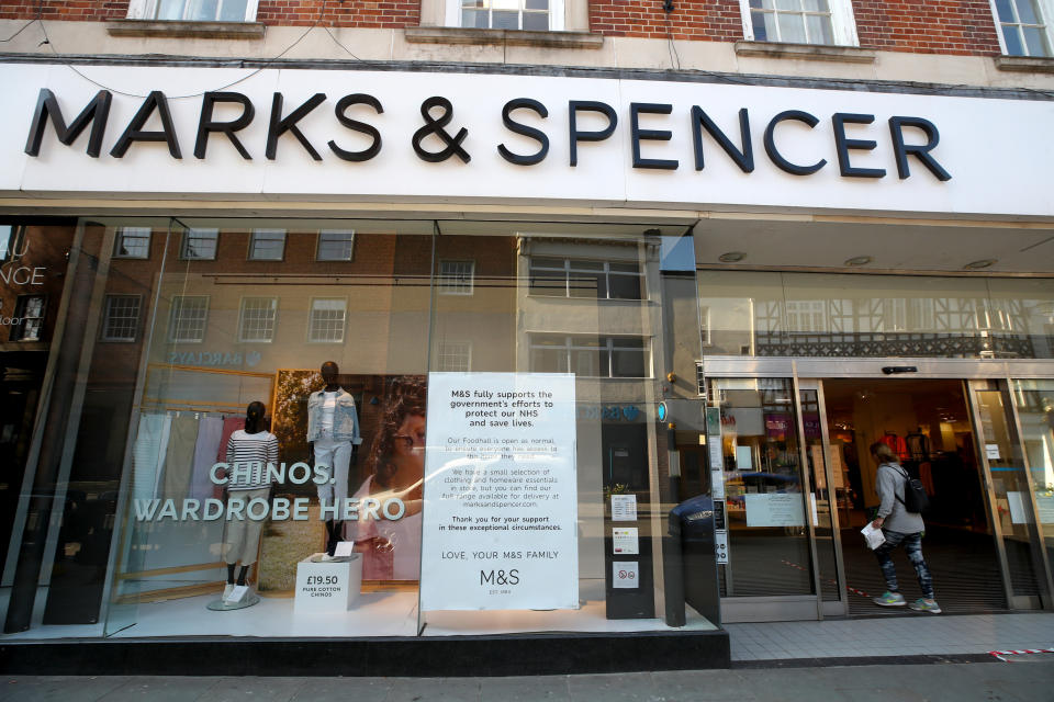 A woman enters a Marks and Spencer store where the food hall remains open in Shrewsbury as the UK continues in lockdown to help curb the spread of the coronavirus.