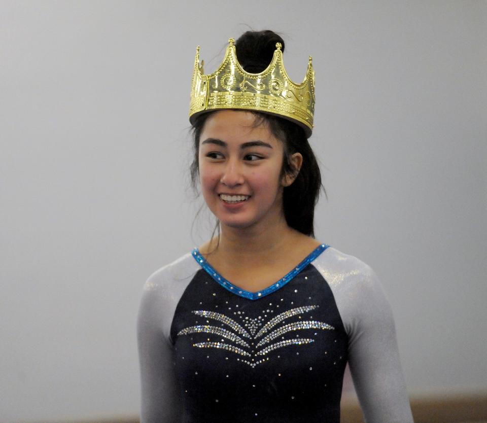 Framingham High School gymnastics team's Angie Leung wears the crown after the vault against Needham High School at Shen's Gymnastics Academy in Holliston, Jan. 14, 2022.  Framingham won, 140.9 to 124.8.