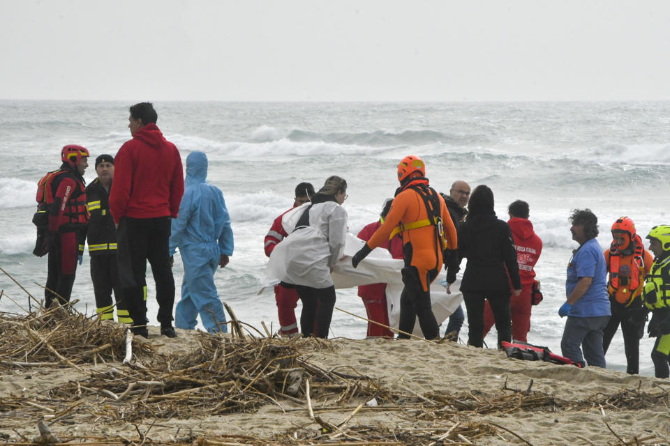 Rescuers recover a body at a beach near Cutro, southern Italy, after a migrant boat broke apart in rough seas, Feb. 26, 2023. / Credit: Giuseppe Pipita/AP