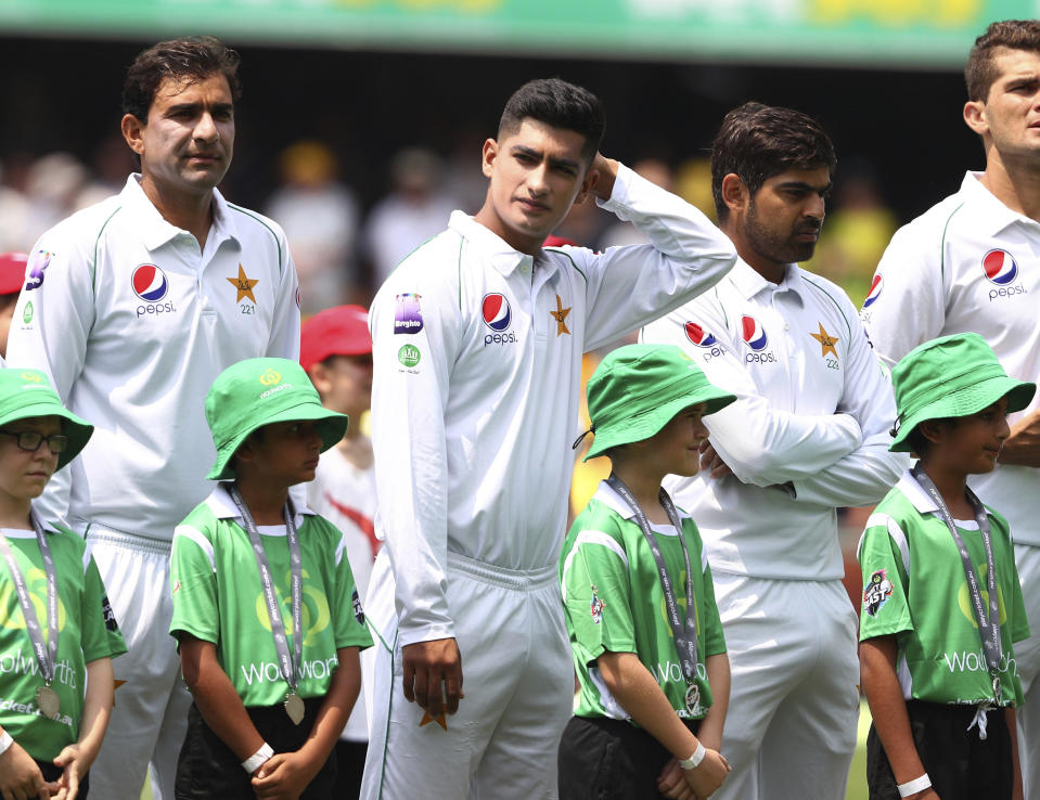 Pakistan's Naseem Shah, center, lines up with his team during the cricket test match between Australia and Pakistan in Brisbane, Australia, Thursday, Nov. 21, 2019. (AP Photo/Tertius Pickard)