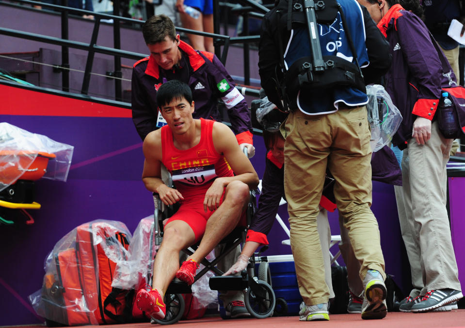 Xiang Liu of China gets assisted off the track after getting injured in the Men's 110m Hurdles Round 1 Heats on Day 11 of the London 2012 Olympic Games at Olympic Stadium on August 7, 2012 in London, England. (Photo by Stu Forster/Getty Images)