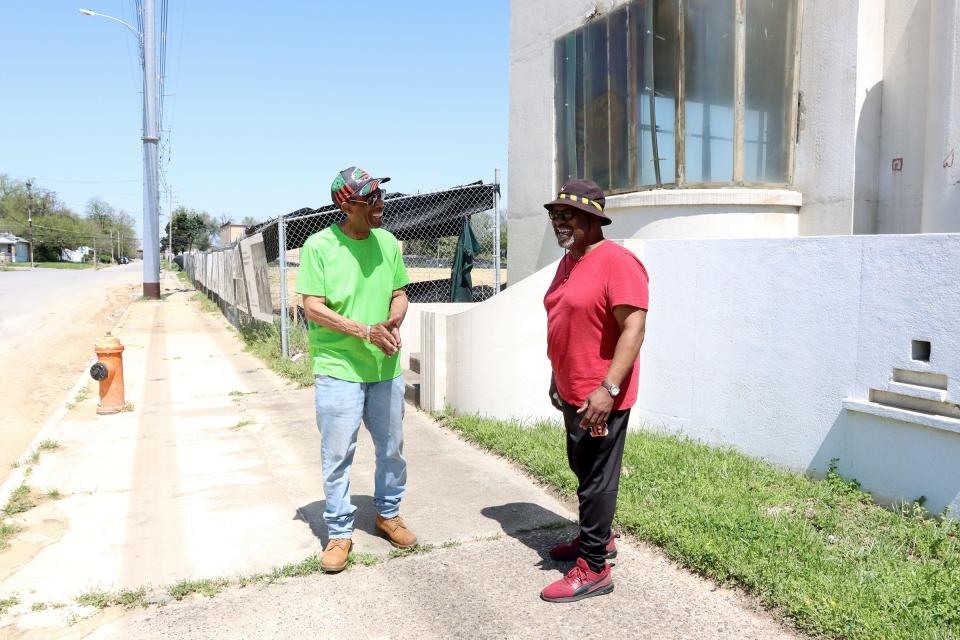 Ron Hargrove (left) and Bruce Sherrod stand outside the former Rhodia chemical site in the Algonquin neighborhood. Both men are members of the Community of Opportunity Advisory Board, which is helping guide redevelopment of the property.
