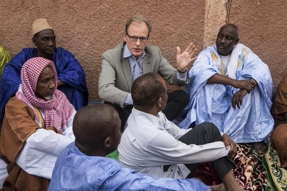 In this Nov. 3, 2017, photo provided by the United Nations, Andrew Gilmour, center, assistant secretary-general for human rights, meets with Peul religious leaders from Mopti to discuss human rights issues and the security situation in the region in Mali. Gilmour says the past decade has seen backlash on human rights on every front, especially on the rights of women and the LGBT communities. (Harandane Dicko/United Nations via AP)