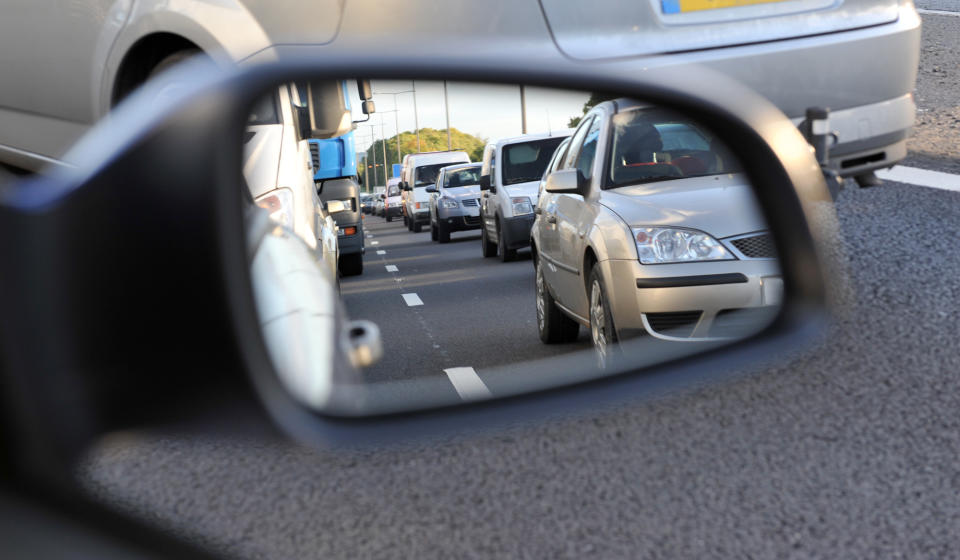  Car insurance Highway traffic reflected in a vehicle wing mirrorlogos and license plate details etc have been removed