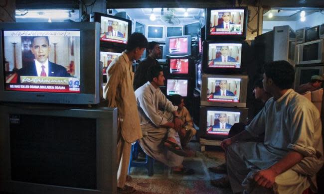 Shopkeepers gather around television screens showing a speech by President Barack Obama as he announced the death of al Qaeda leader Osama bin Laden at a market in Quetta May 2, 2011.