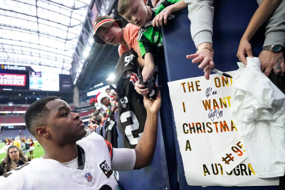 Cleveland Browns wide receiver Amari Cooper gives away his gloves to a fan after a game against the Houston Texans on Sunday in Houston.