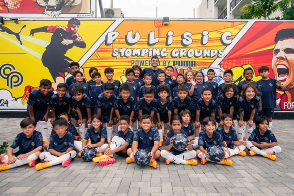 U.S. national team captain Christian Pulisic visits with Miami-area children who participated in his Stomping Grounds program in Little Havana, which provides free soccer and chess clinics.