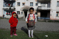 Afghan migrant children pose as they stand in front of their homes in Kars, eastern Turkey, April 11, 2018. Picture taken April 11, 2018. REUTERS/Umit Bektas