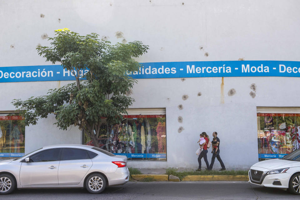 Bullet holes cover the wall of a home decor store after a recent shootout in Culiacan, Mexico, Saturday, Oct. 26, 2019. The physical scars of the Oct. 17 gunbattles _ what’s come to be known as “black Thursday” by residents of Culiacan, the capital of Sinaloa and a stronghold of the Sinaloa cartel long led by Joaquín “El Chapo” Guzmán _ are beginning to heal, but residents are still coming to grips with the worst cartel violence in recent memory. (AP Photo/Augusto Zurita)