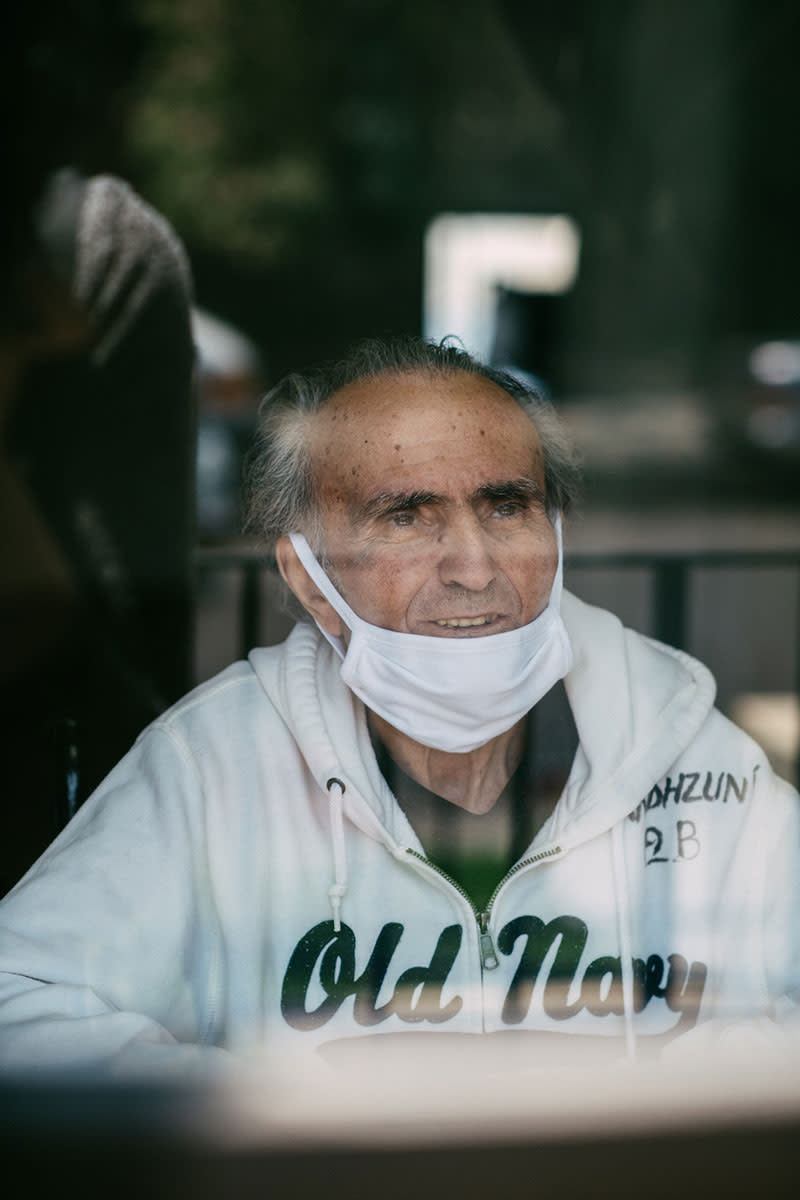 Landzhuni Oaanesyan, 81, is visited by his daughter, Armenuni Gregorian, and son, Armen Oaanesyan. Landzhuni recently recovered from COVID-19. | Isadora Kosofsky for TIME