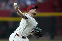 Arizona Diamondbacks starting pitcher Merrill Kelly throws against the Colorado Rockies during the first inning of a baseball game Friday, March 29, 2024, in Phoenix. (AP Photo/Ross D. Franklin)