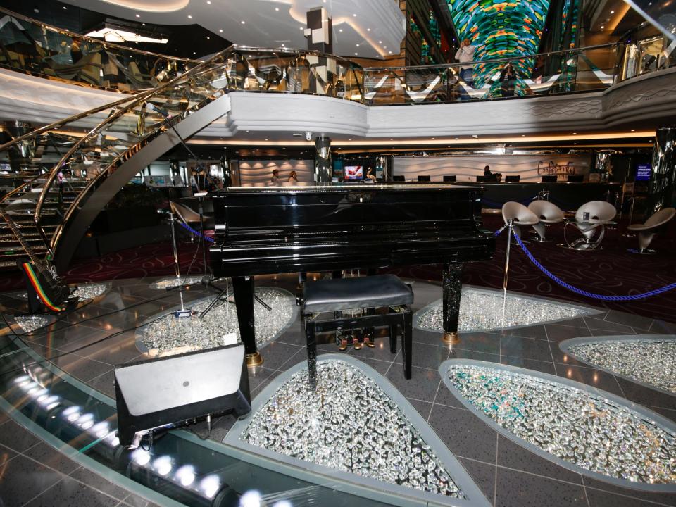 A piano on a glittering floor in the MSC Meraviglia