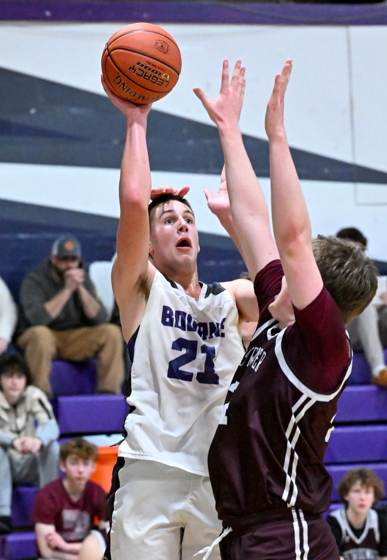 Mike Dankert of Bourne is fouled from behind as he shoots over Thomas Stapleton of West Bridgewater.