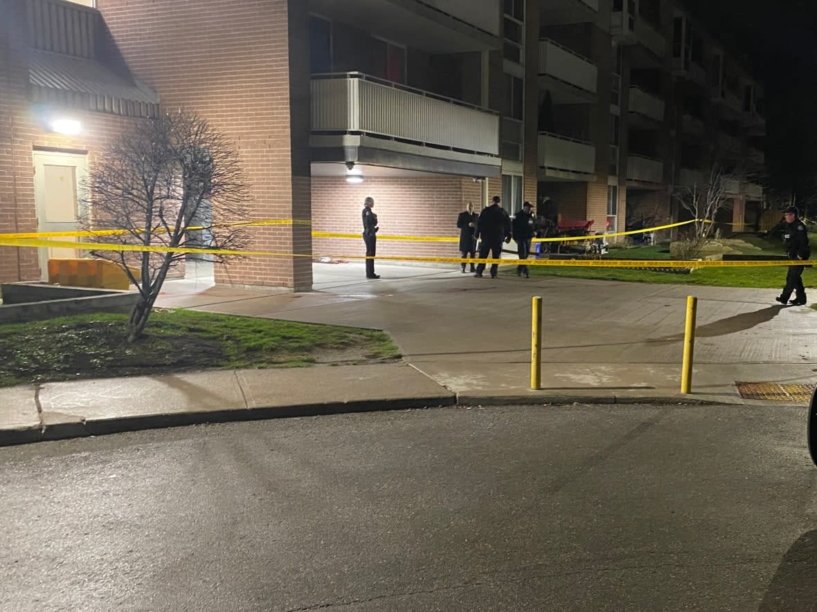Police are shown here near the scene of a fatal stabbing in an apartment building on Danforth Avenue in the early morning hours Tuesday. (Paul Smith/CBC - image credit)