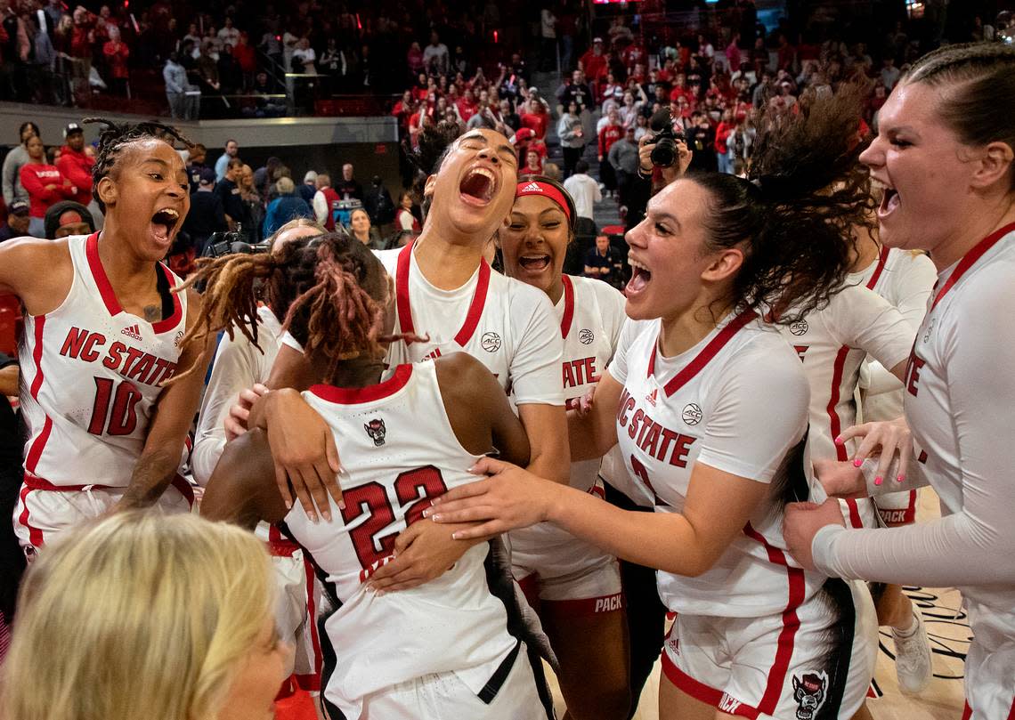 N.C. State players celebrate after defeating UConn 92-81 on Sunday, Nov. 12, 2023, at Reynolds Coliseum in Raleigh, N.C. Kaitlin McKeown/kmckeown@newsobserver.com