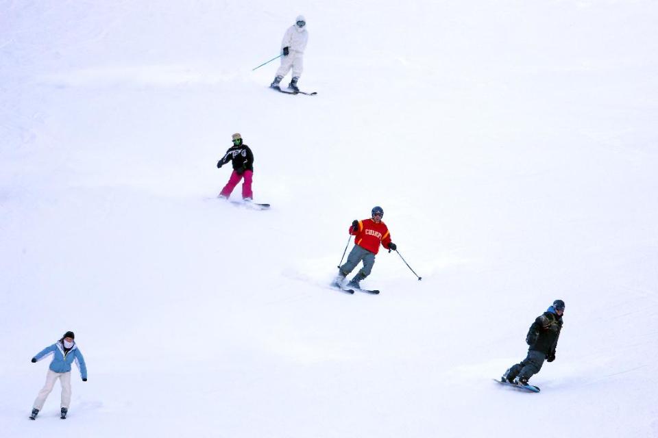 FILE - In this Oct. 13, 2013 photo provided by Colorado Ski Country USA, skiers enjoy opening day at Arapahoe Basin Ski Area in Colorado. Colorado Ski Country USA, a trade association that represents 21 resorts, is informing visitors through social media about the new pot laws, which were passed last year and legalize marijuana possession in small amounts for adults over 21, including out-of-state visitors. Ski industry officials note that it's still illegal to smoke marijuana in public and on federal land, where 90 percent of Colorado's ski resorts are located. (AP Photo/Colorado Ski Country USA, Jack Dempsey, File)