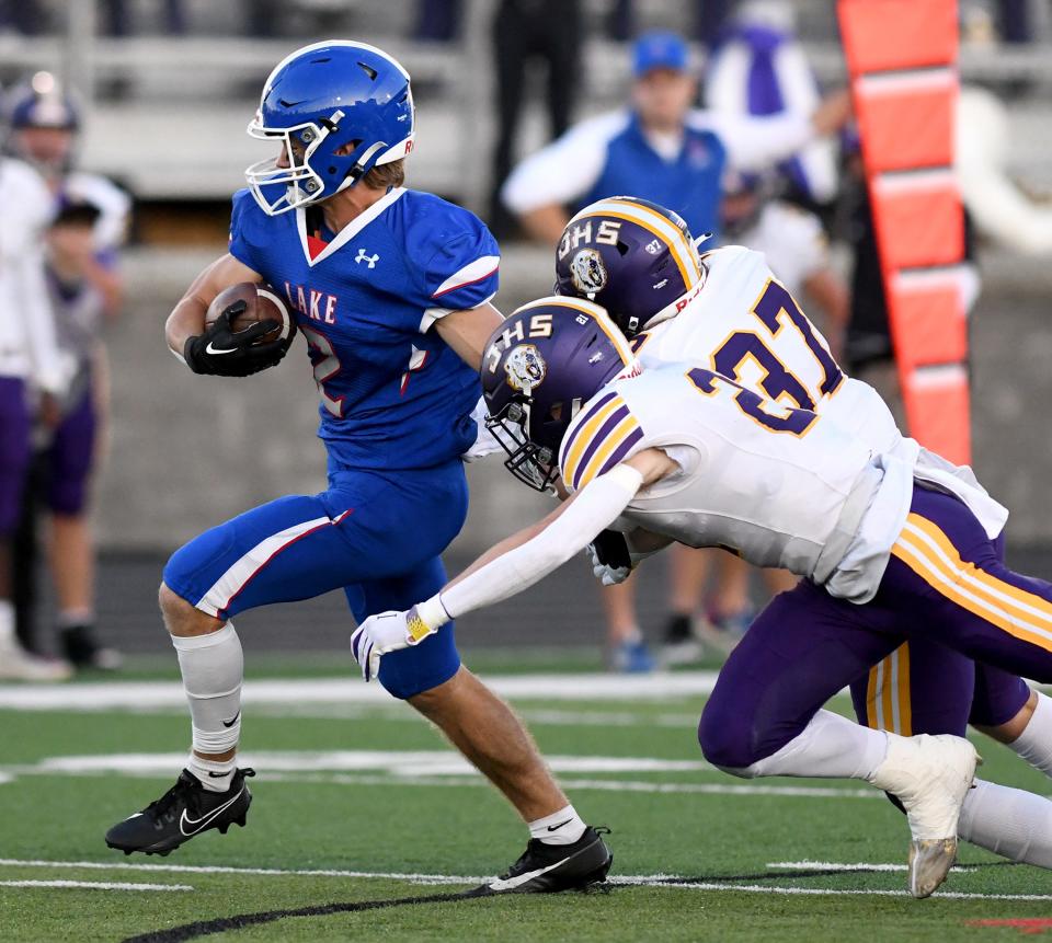 Lake running back Nathan Baker escapes a pair of Jackson defenders, Sept 22, 2023.