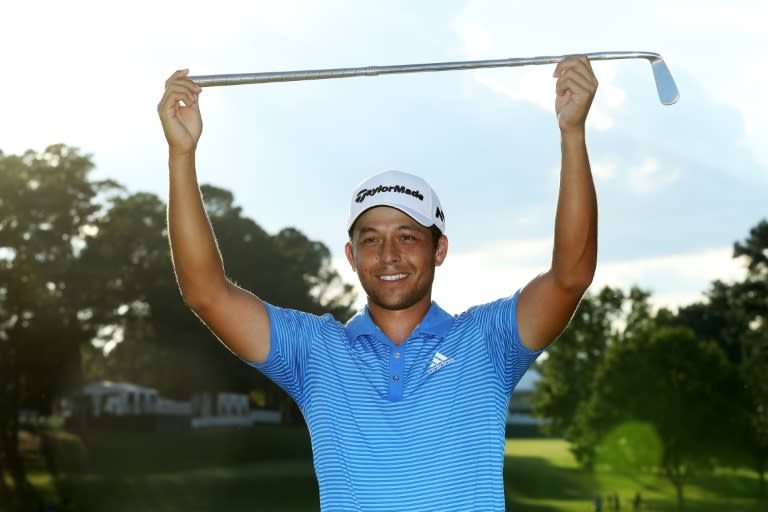 Xander Schauffele of the US celebrates with the Calamity Jane trophy on the 18th green after winning the TOUR Championship, at East Lake Golf Club in Atlanta, Georgia, on September 24, 2017