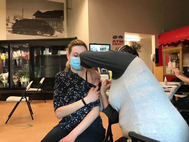 N.W.T. resident Kristy Hawes gets vaccinated at a pop-up vaccine clinic in June. (Liny Lamberink/CBC - image credit)