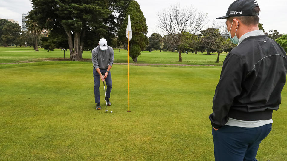 A golfer, pictured here putting at Albert Park Golf Course in Melbourne.