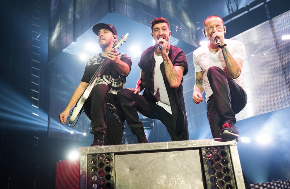 <p>Mike Shinoda, Austin Carlile and Chester Bennington on stage in 2003. (REX/Shuttershock) </p>