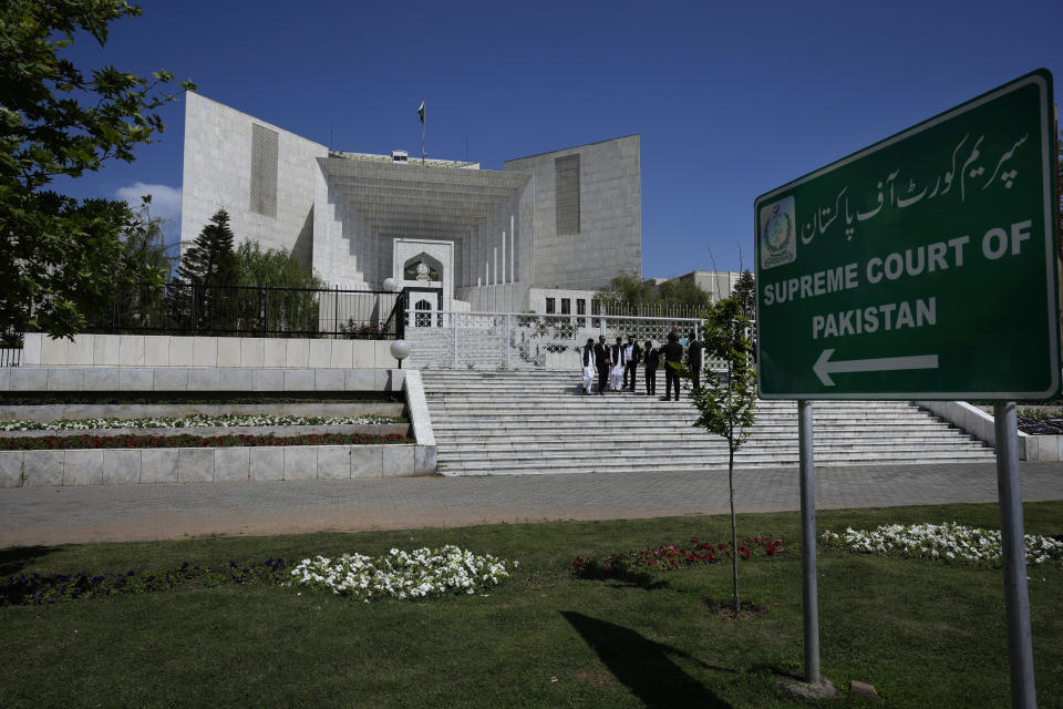 Lawyers gather outside the Supreme Court as they wait for court decision regarding provincial elections, in Islamabad, Pakistan, Tuesday, April 4, 2023. Pakistan's Supreme Court ruled a panel's decision to delay provincial elections was unconstitutional and ordered the votes held by May 14, according to a lawyer involved in the case. (AP Photo/Anjum Naveed)