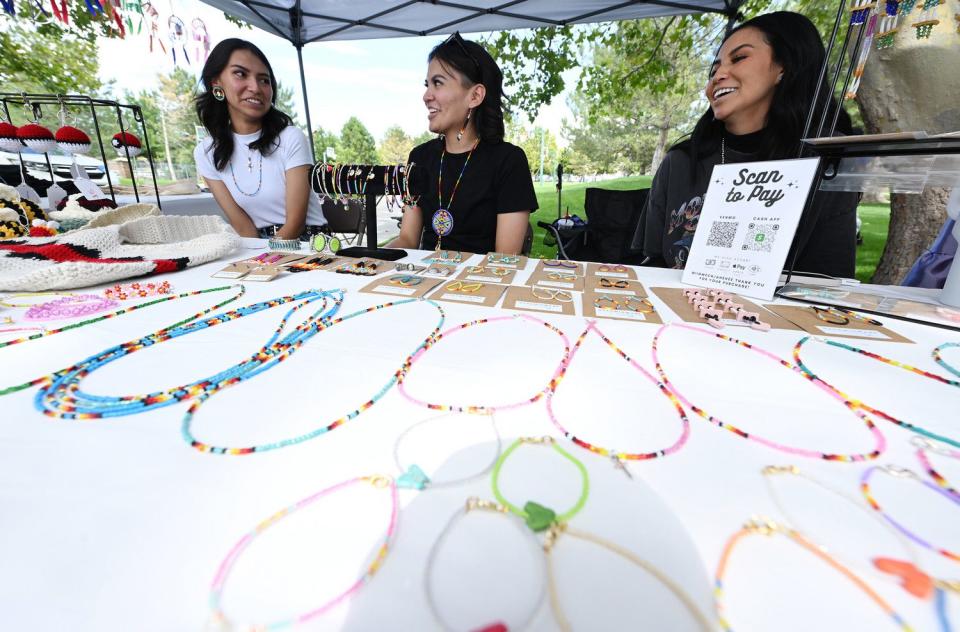 Sisters Britney, Rachel and Kim Tourangeau talk while sitting at their craft booth at Utah Native Market Days at Thanksgiving Point in Lehi on Friday. All proceeds are going to Native student scholarships. There was hoop dancing, food and crafts.