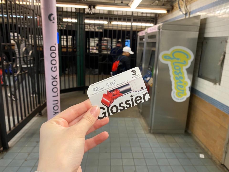 A Glossier Metrocard and subway decor in New York City.