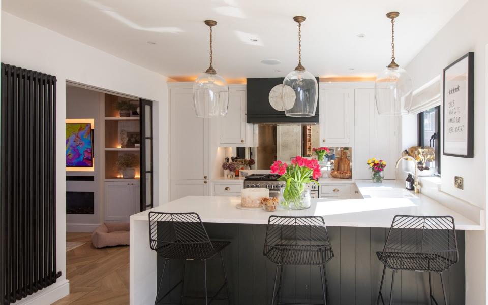 The pocket doors separating kitchen and living room can disappear into the wall to give the downstairs a more open plan feel