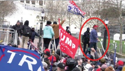 Screenshots from an open source video showing Schubert (circled in red) after breaching police barriers.