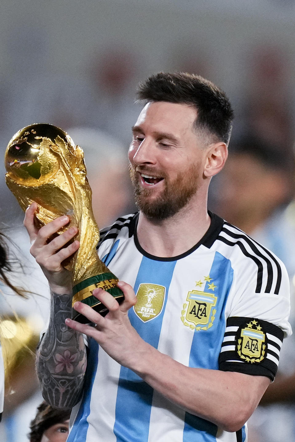 Argentina's Lionel Messi holds the FIFA World Cup trophy during a celebration ceremony for local fans after an international friendly soccer match against Panama at the Monumental stadium in Buenos Aires, Argentina, Thursday, March 23, 2023. (AP Photo/Natacha Pisarenko)