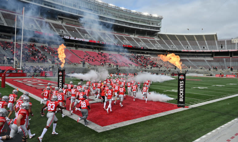 Ohio State players run onto the field before a game in September.