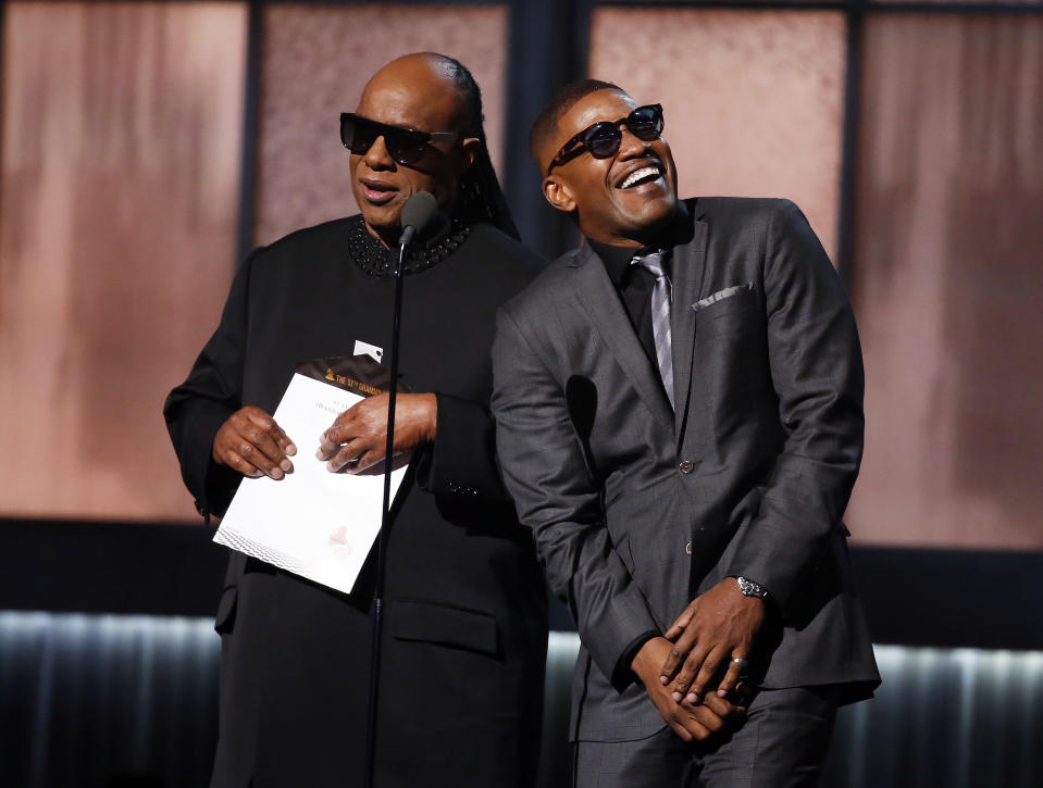 Musician Stevie Wonder and actor Jamie Foxx, who is impersonating Ray Charles, present the Record of the Year award during the 57th annual Grammy Awards in Los Angeles, California February 8, 2015.  REUTERS/Lucy Nicholson  (UNITED STATES - TAGS: ENTERTAINMENT) (GRAMMYS-SHOW)
