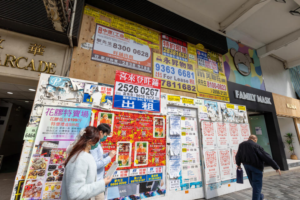 Hong Kong - February 28, 2022 : People walk past a closed shop advertised for leasing in Nathan Road, Tsim Sha Tsui, Kowloon, Hong Kong.