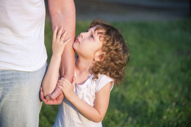 Dad and pretty little daughter in the park