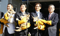 REUTERS/Jo Yong hak South Korean stem cell scientist Hwang Woo-suk (R) and Gyeonggi province governor Kim Moon-su (2nd R) hold a cloned coyote during a donation ceremony at a wildlife protection centre in Pyeongtaek, south of Seoul, October 17, 2011. Hwang on Monday donated eight coyotes that he and his research team at the Sooam Biotech Research Foundation cloned to help the endangered species, to the Gyeonggi provincial government, local media reported. Hwang was at the heart of a research fraud case in 2005, where a team he led was found by review boards to have manipulated key data in its studies on cloning stem cells. South Korea, considered then a global leader in human embryonic stem cell research, all but put stem cell research into deep freeze as a result of the scandal.