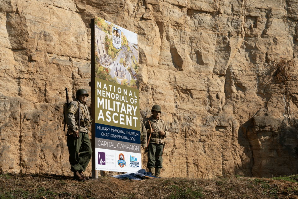 Military reenactors stand in front of the limestone cliffs in Grafton, where the cliff portion of the new memorial will be built. Once complete, it will resemble Pointe du Hoc, a famous cliff located between the two D-Day beaches where American troops landed in 1944.