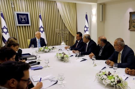 Memebers of the United List party, sits next to Israeli President Reuven Rivlin as he began talks with political parties over who should form a new government, at his residence in Jerusalem