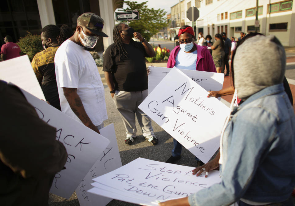 Scores of demonstrators gather in front of Elizabeth City, N.C.,, City Hall on Wednesday evening, April 21, 2021, to protest the police involved shooting earlier in the day. A North Carolina deputy shot and killed a Black man while executing a search warrant Wednesday, authorities said, spurring an outcry from a crowd of dozens that immediately gathered at the scene and demanded law enforcement accountability. (Stephen M. Katz