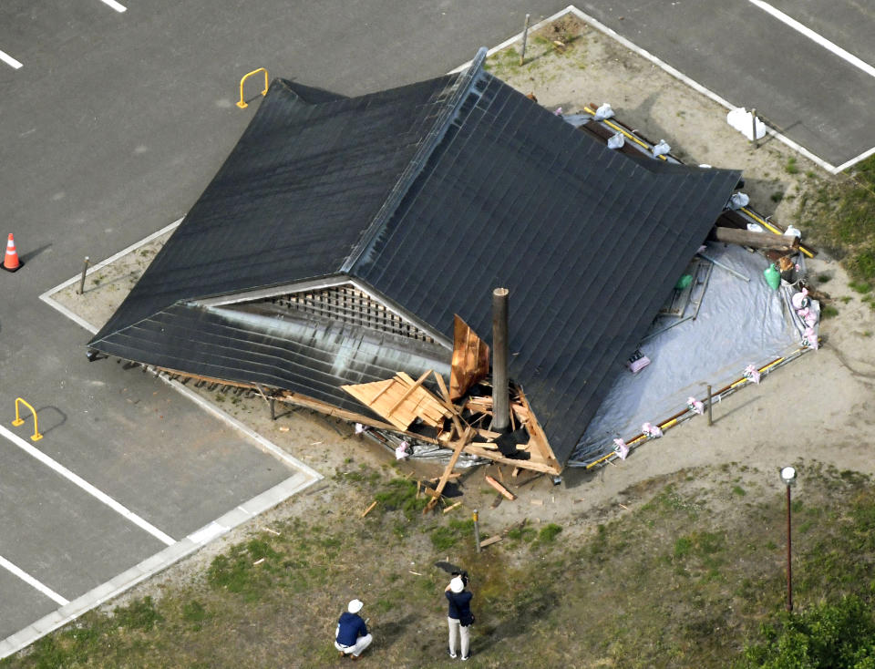 The roof of the wooden sumo building falls on the site of the Oizumi Elementary School in Tsuruoka, Yamagata prefecture, northwestern Japan, Wednesday, June 19, 2019, after an earthquake. The powerful earthquake jolted northwestern Japan late Tuesday, prompting officials to issue a tsunami warning along the coast which was lifted about 2 ½ hours later. Tsuruoka city officials were helping coastal residents evacuate to higher ground as a precaution. (Kyodo News via AP)