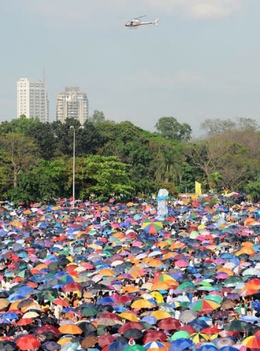 A helicopter hovers above a sea of umbrellas as Iglesia ni Cristo (Church of Christ) members gather at the Quirino grandstand for a rally in Manila. About a million members of the influential sect held rallies in the Philippines, police said, in a show of force amid perceived political tension with once staunch ally President Benigno Aquino