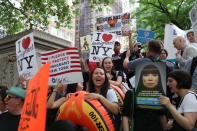 <p>Protesters chant slogans and hold up a signs at the start of a protest again the U.S. immigration policies on the terrace outside the New York Public Library on 42nd Street in New York City on June 20, 2018. (Photo: Gordon Donovan/Yahoo News) </p>